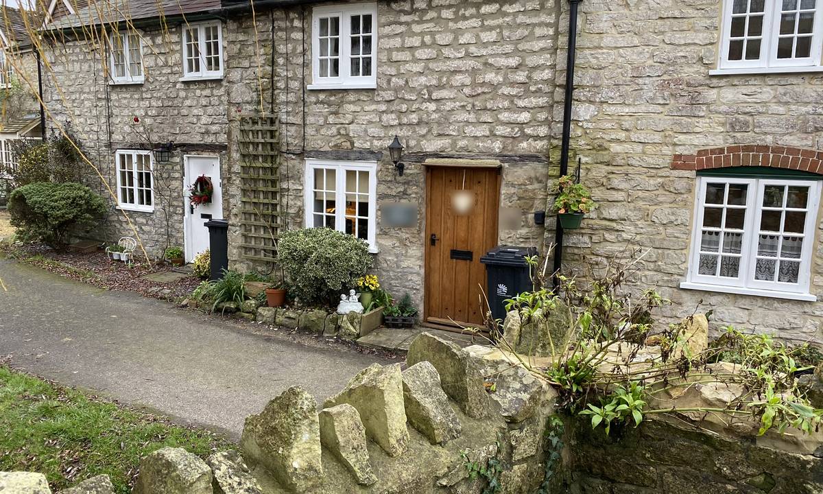 A terrace of old stone cottages in a Dorset village